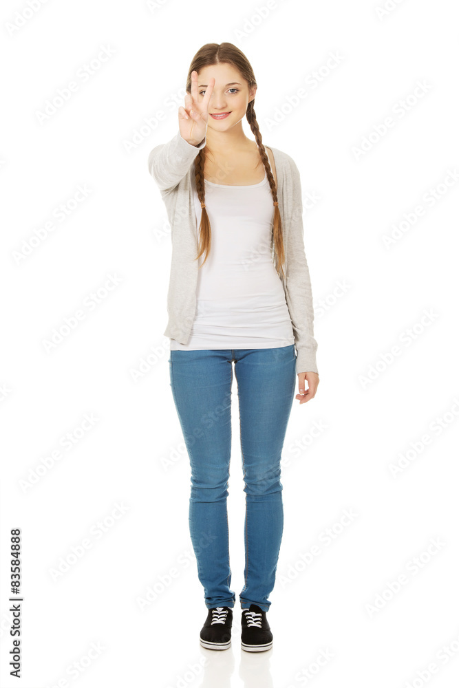 Happy teenager with victory gesture. Happy teenager with victory gesture.