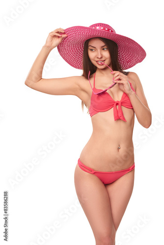 Woman in pink swimsuit and hat