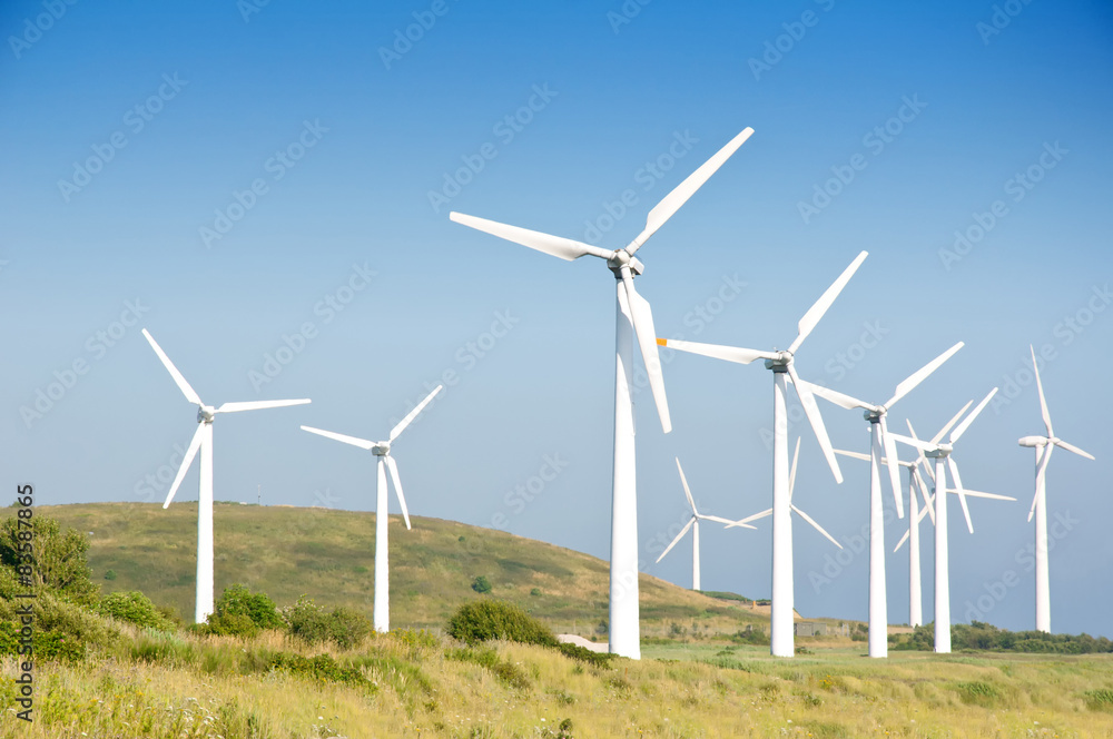 green meadow with Wind turbines generating electricity green meadow with Wind turbines generating electricity