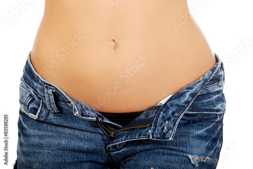 Woman with unbuttoned jeans.