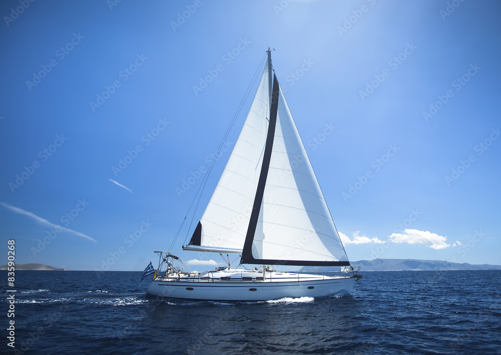 Sailing Yacht from sail regatta race on blue water Sea.