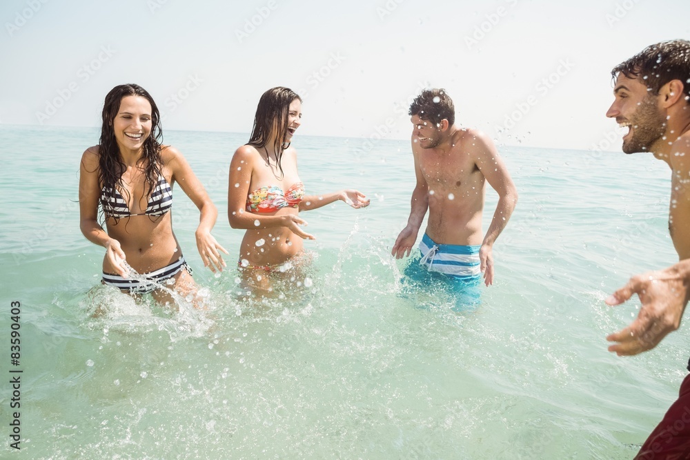 group of friends in swimsuits having fun on the sea 