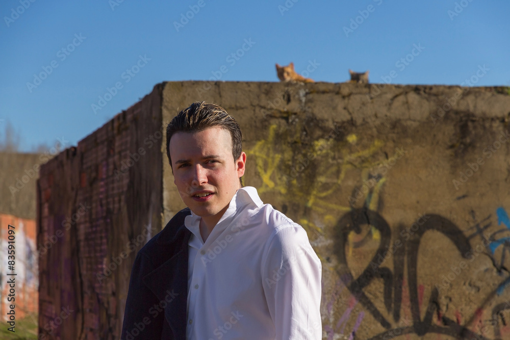 Stylish Young Man with Cats and Graffiti
