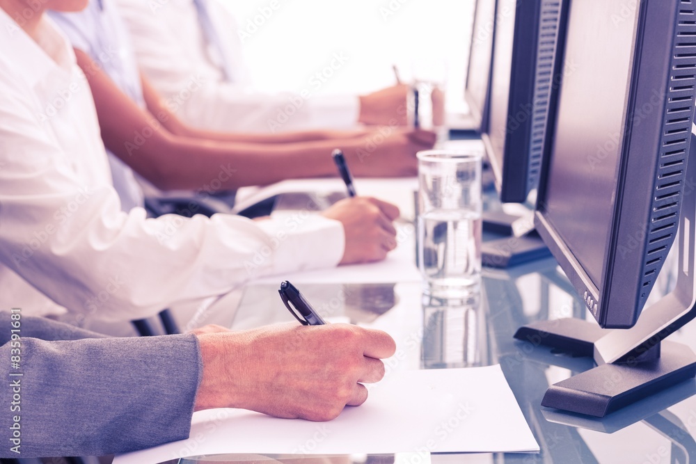 Close up view of business people writing on paper Close up view of business people writing on paper