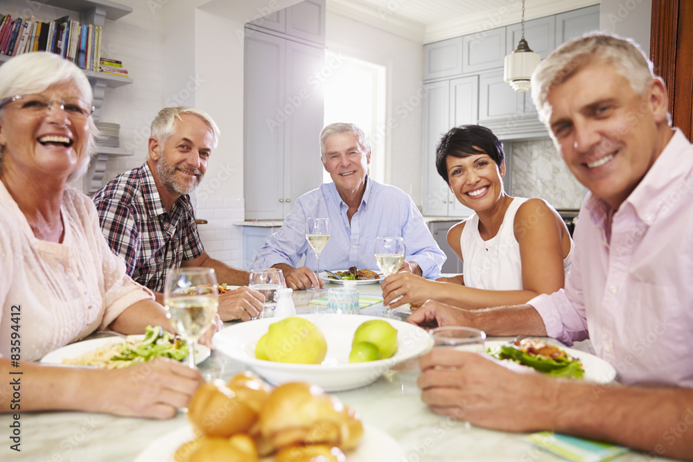 Portrait Of Mature Friends Enjoying Meal At Home Together Portrait Of Mature Friends Enjoying Meal At Home Together