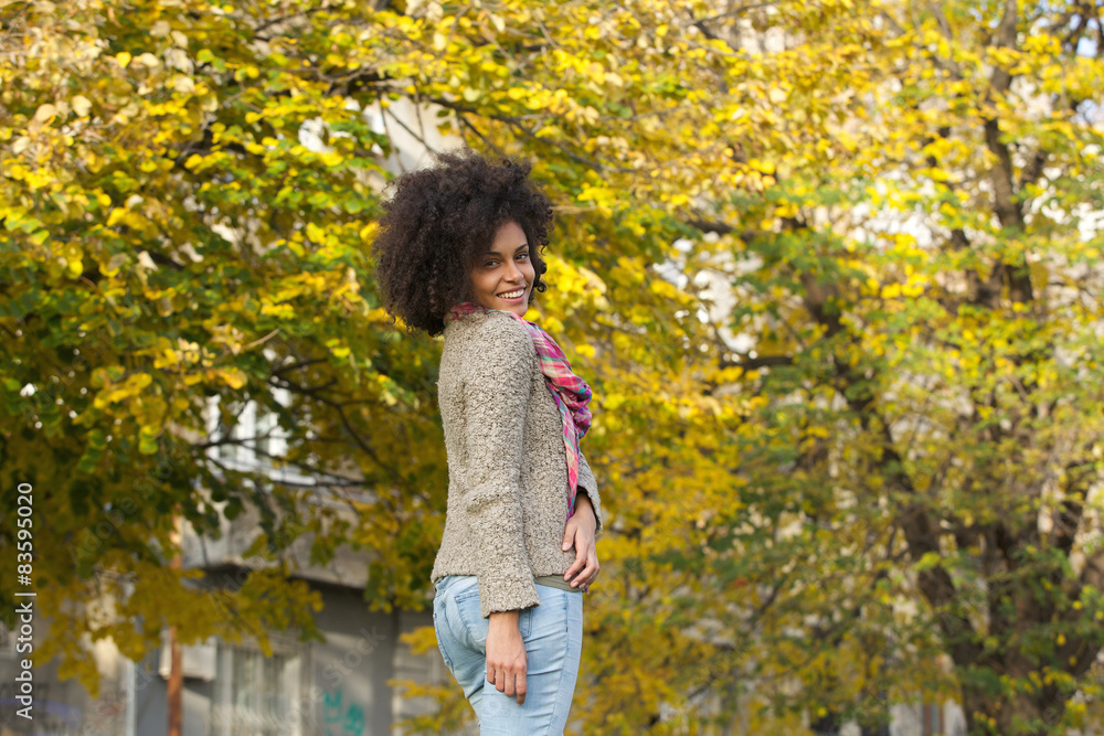 Cheerful young woman smiling in autumn