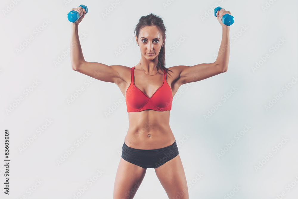 athletic woman pumping muscles doing workout lifting up dumbbell athletic woman pumping muscles doing workout lifting up dumbbell