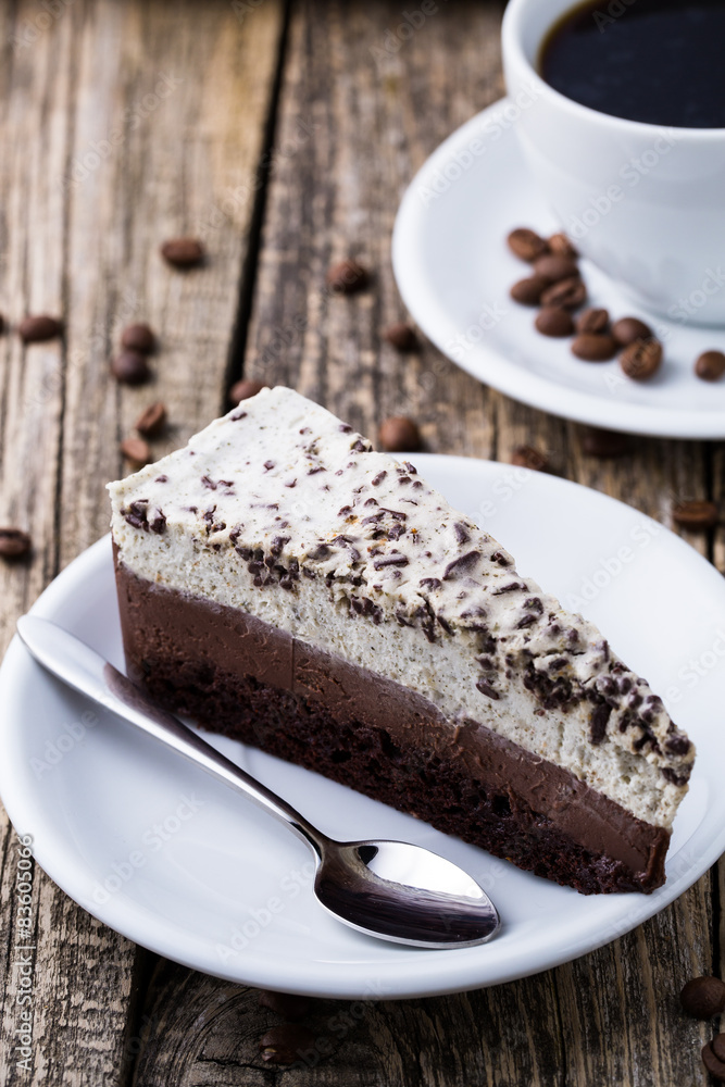 Chocolate dessert with coffee cup and coffee beans on wooden bac