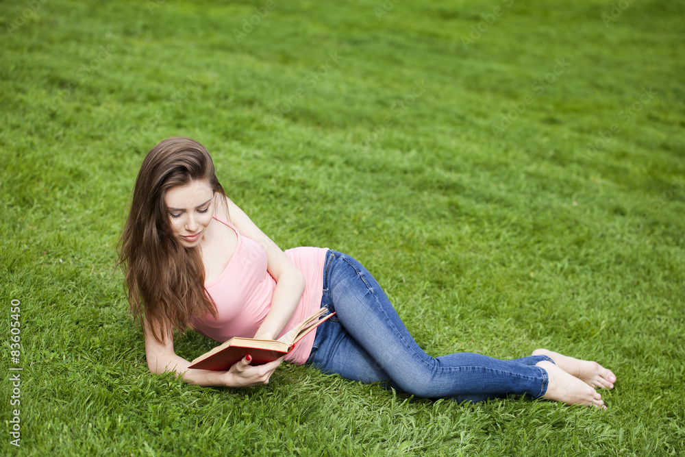 Young beautiful brunette girl reading a book outdoor Young beautiful brunette girl reading a book outdoor