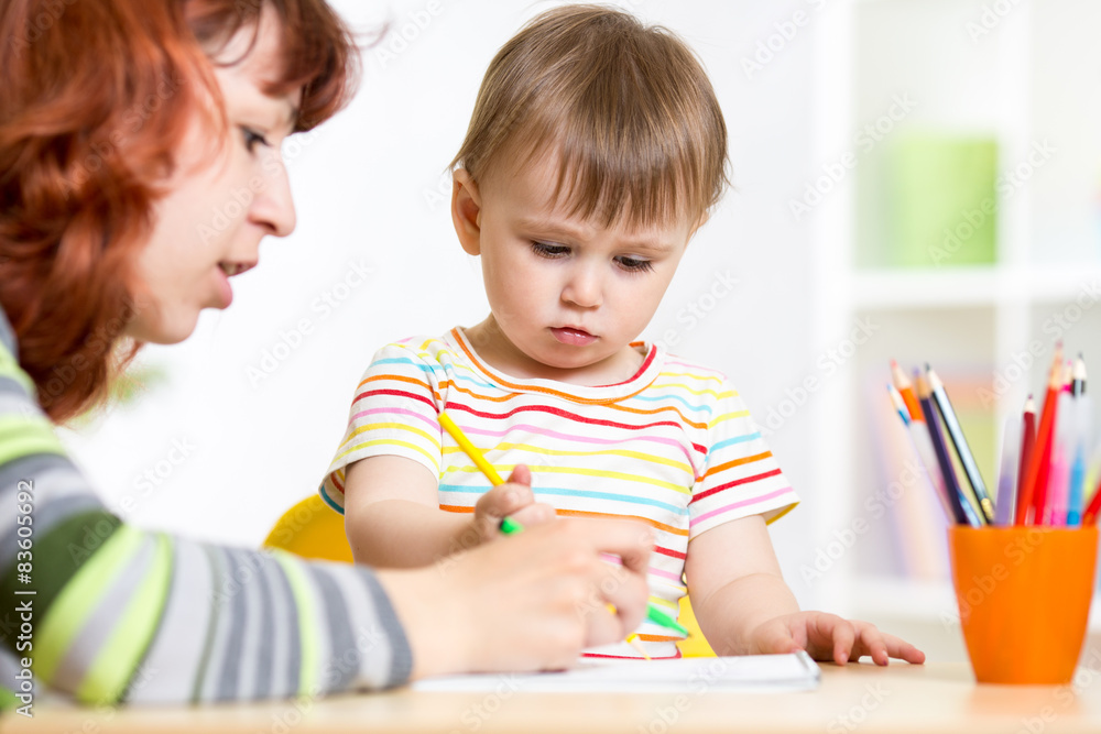 Mother and daughter child draw and paint together Mother and daughter child draw and paint together