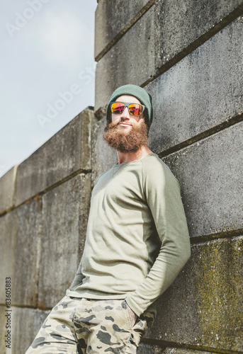 Relaxed young man with a big bushy beard © ysbrandcosijn