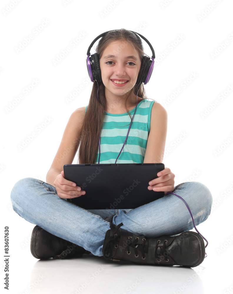 Beautiful pre-teen girl using a tablet computer Beautiful pre-teen girl using a tablet computer