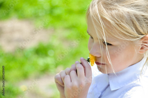 Girl  smelling dandelion