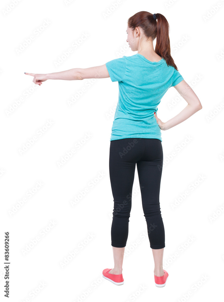 Back view of pointing woman in sportswear. Back view of pointing woman in sportswear.