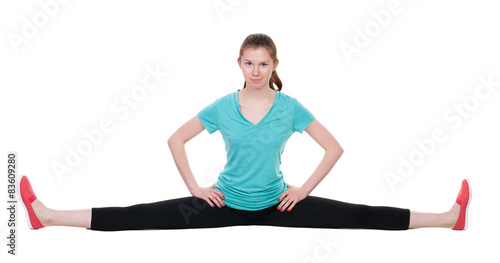 Front view of the girl in sportswear sitting on the longitudinal