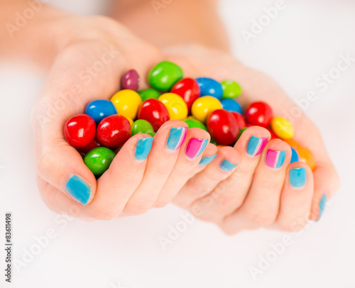 Bright candies in woman's hands