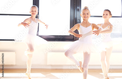 Group of young ballerinas practicing pirouettes