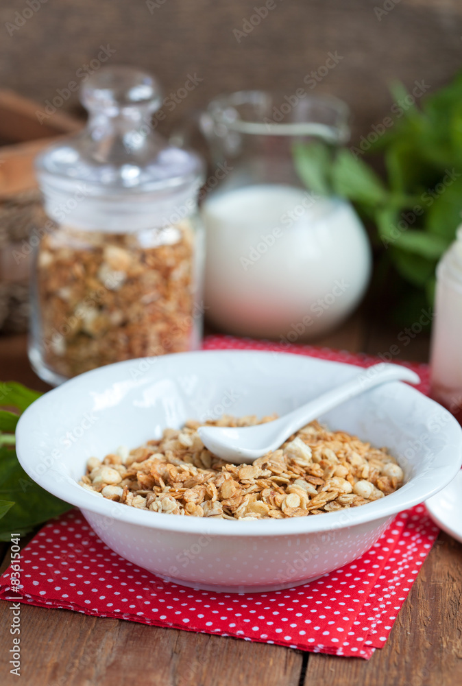 Breakfast: homemade granola in a white plate, yogurt with jam Breakfast: homemade granola in a white plate, yogurt with jam