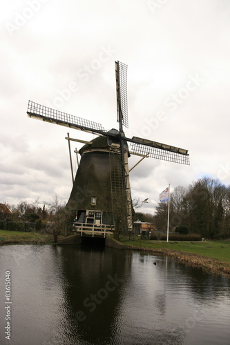 Windmill in the Netherlands, with water in the foreground