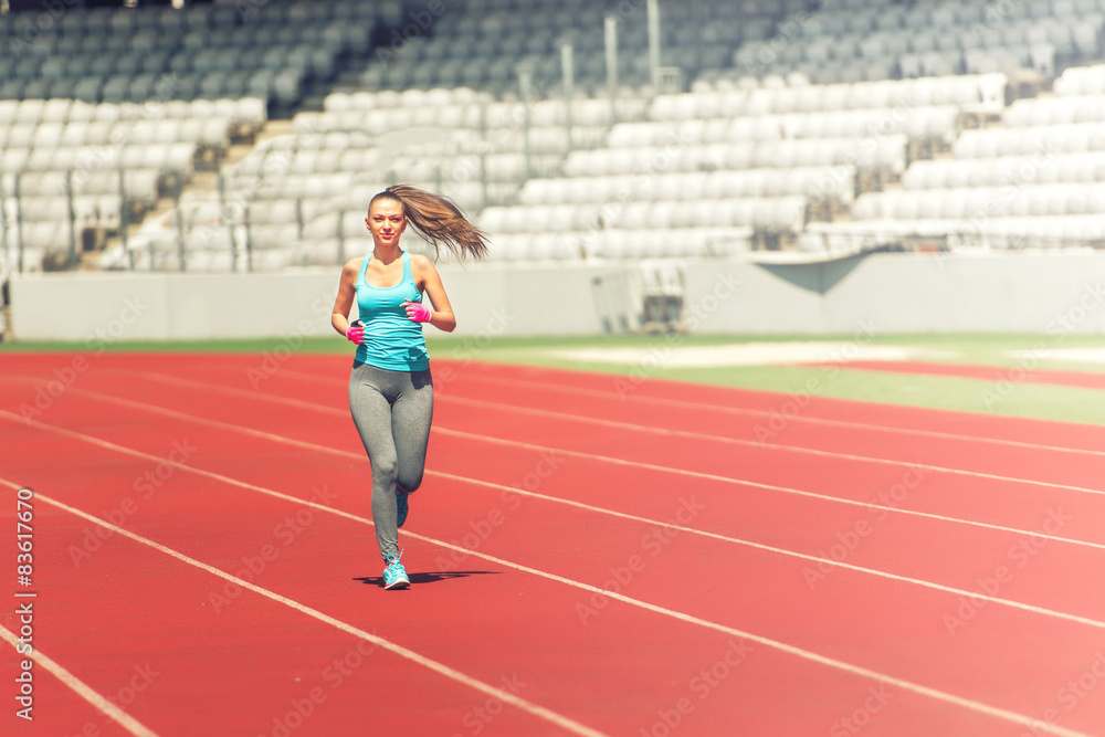 Obraz premium Athlete running on professional track, preparing for marathon