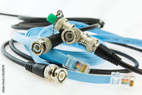 Photos older coaxial ethernet cable with BNC terminals and new with RJ4