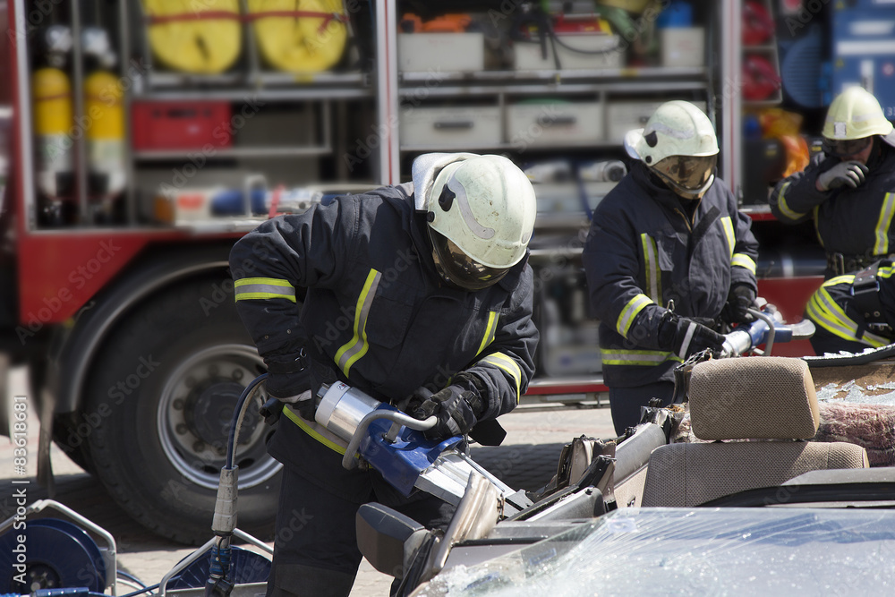 firefighters with the pneumatic shears open the car doors firefighters with the pneumatic shears open the car doors
