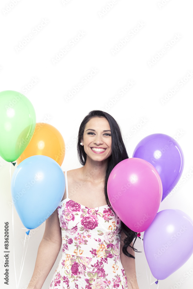 Smiling Young Pretty Brunette Woman holding Colorful Balloons