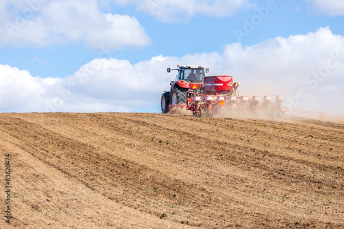 Tractor harrowing the field