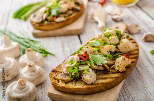 Toast with mushrooms and fried chicken, sprinkled with