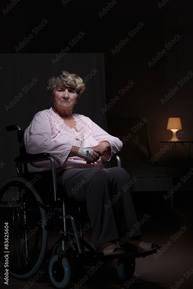 Fototapeta premium Lonely woman sitting on wheelchair