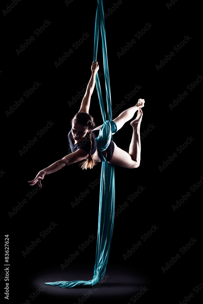 Fototapeta Young woman gymnast with blue gymnastic aerial silks