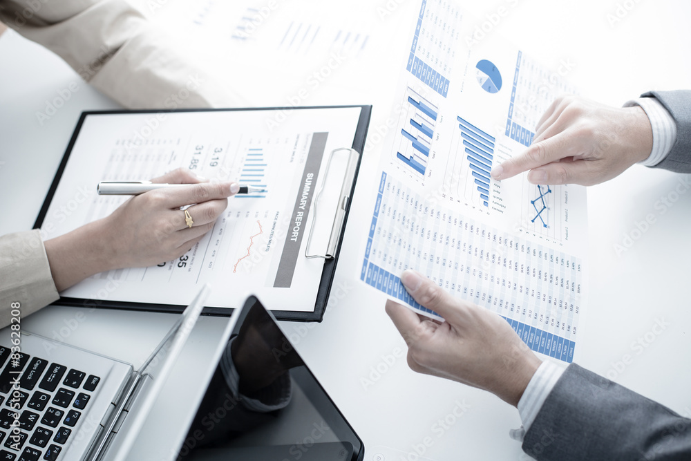 Business people discussing the charts and graphs showing the res Business people discussing the charts and graphs showing the res