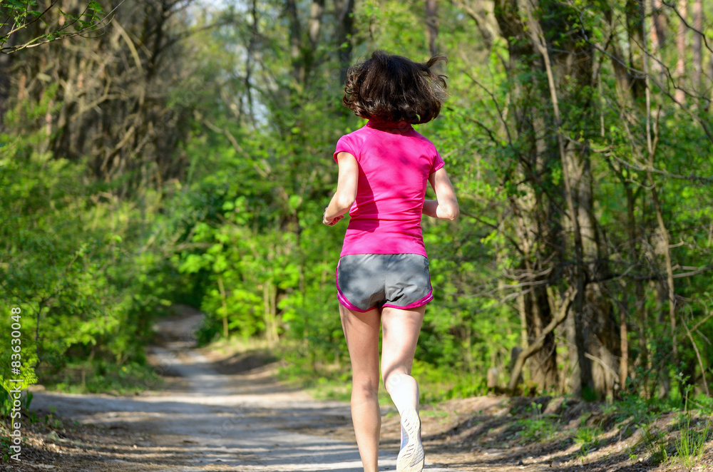 Woman runner jogging outdoors in forest, exercising, sport Woman runner jogging outdoors in forest, exercising, sport