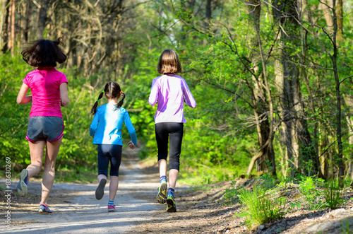 Fototapeta Naklejka Na Ścianę i Meble -  Family sport, mother and kids jogging, running in forest
