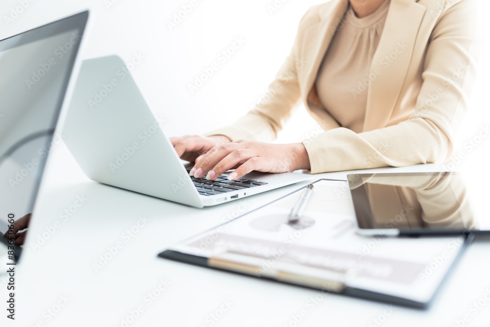 Unrecognizable business person analyzing graphs and taking notes Unrecognizable business person analyzing graphs and taking notes
