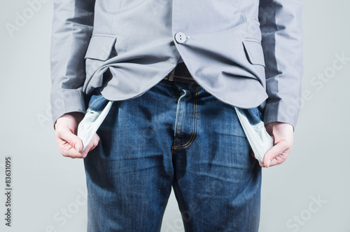 Close up shot of man holding out his empty pockets