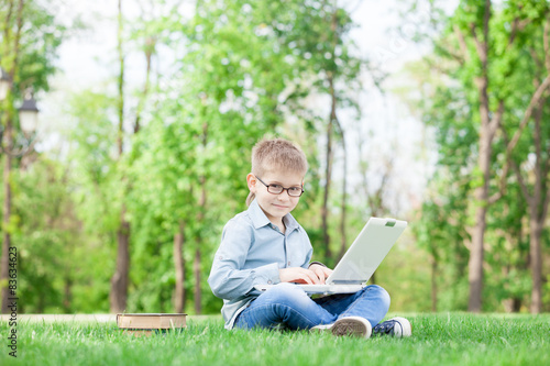 boy with a books and laptop computer