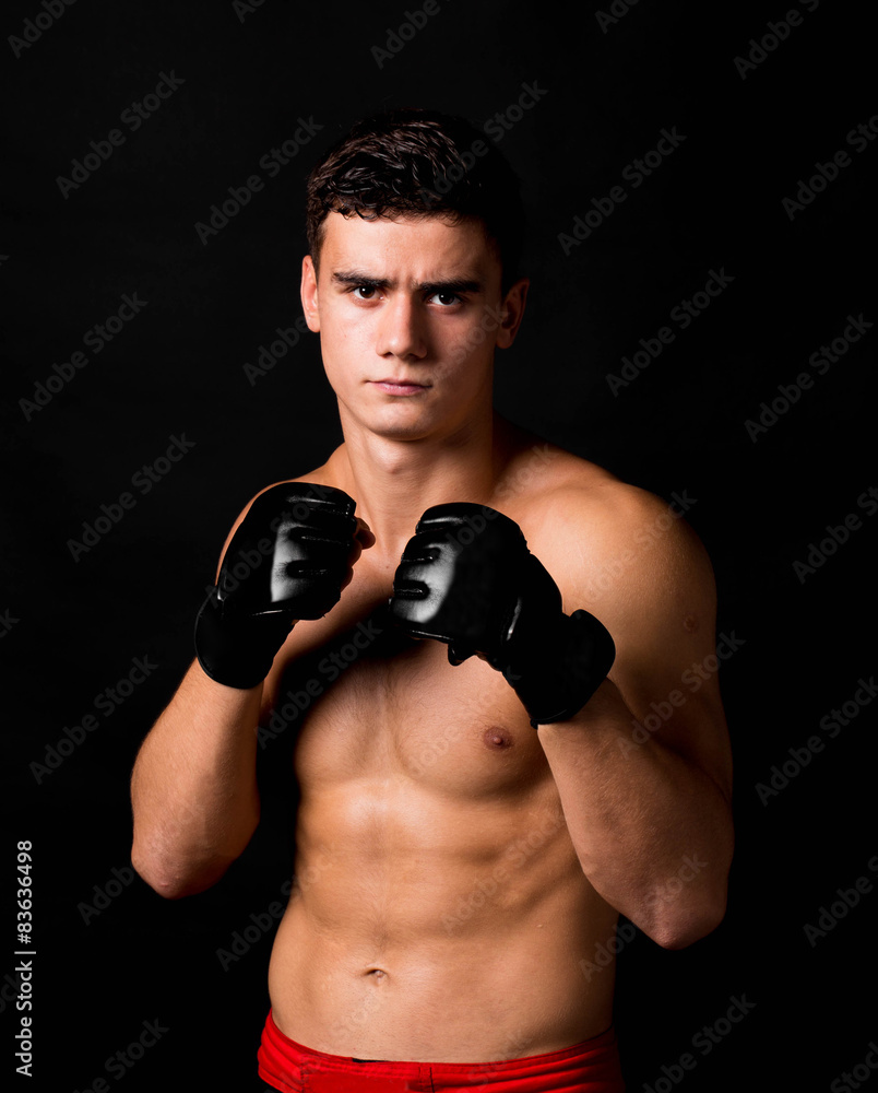 Portrait of boxer hitting in gloves.