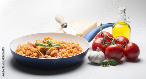 pan with macaroni and ingredients isolated on white background