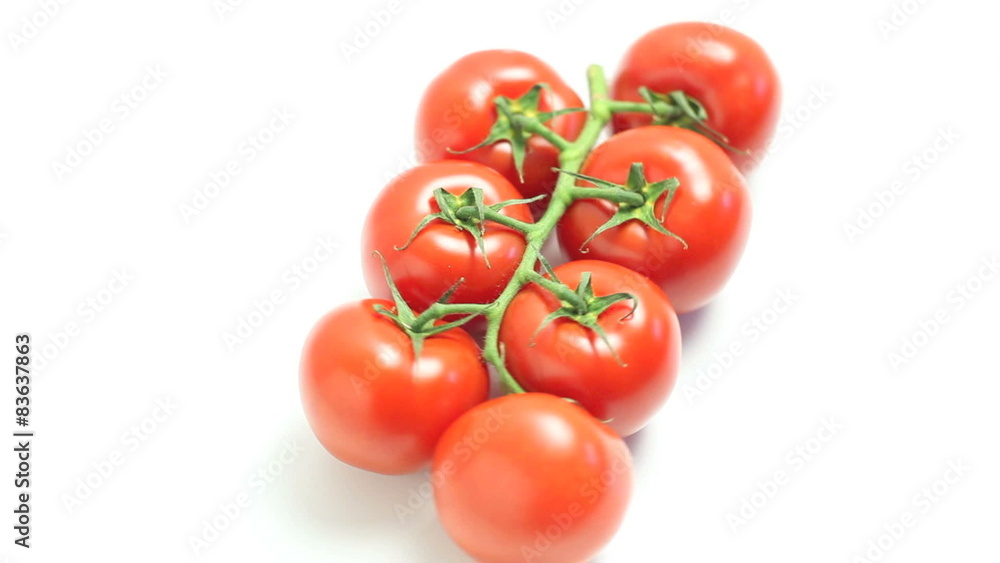 Fine ripe tomatoes on the vine rotating on white background Fine ripe tomatoes on the vine rotating on white background