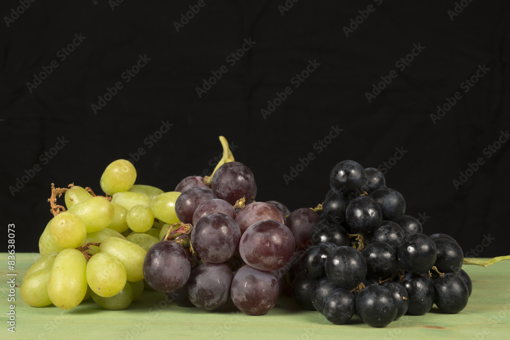 Grape fruit on green table with black background