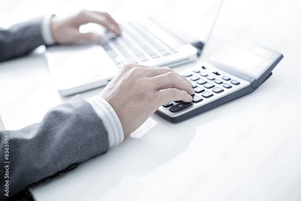 Closeup of businessman hands typing on laptop computer Closeup of businessman hands typing on laptop computer