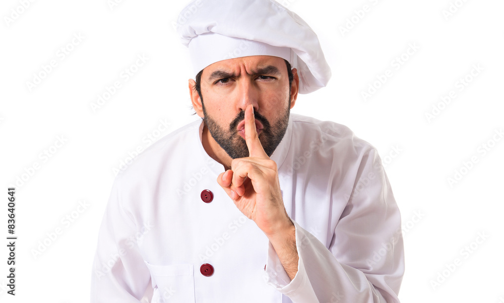 Chef making silence gesture over white background Chef making silence gesture over white background