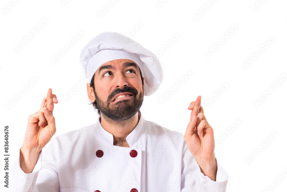 Chef with his fingers crossing over white background Chef with his fingers crossing over white background