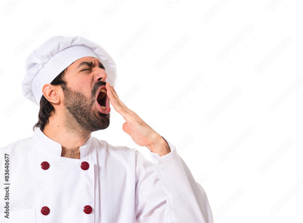 Chef yawning over white background Chef yawning over white background