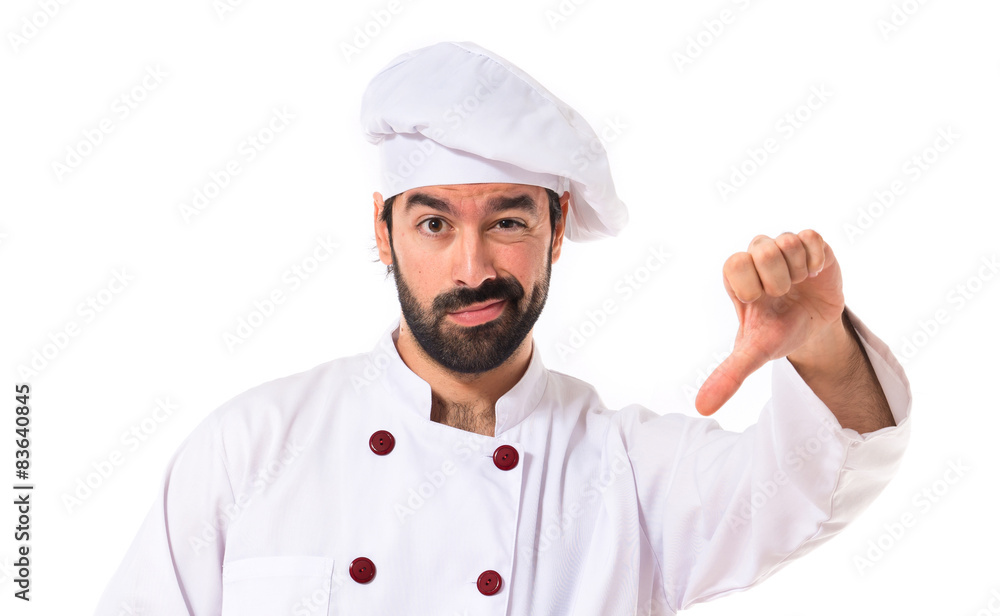 Chef doing a bad signal over white background