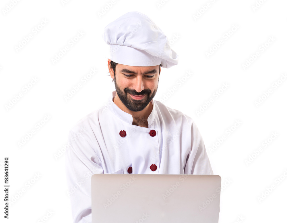 Chef with laptop over isolated white background Chef with laptop over isolated white background