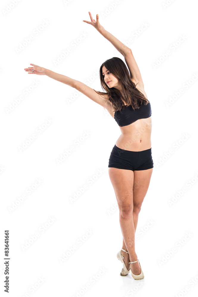 Young ballet dancer posing over white background