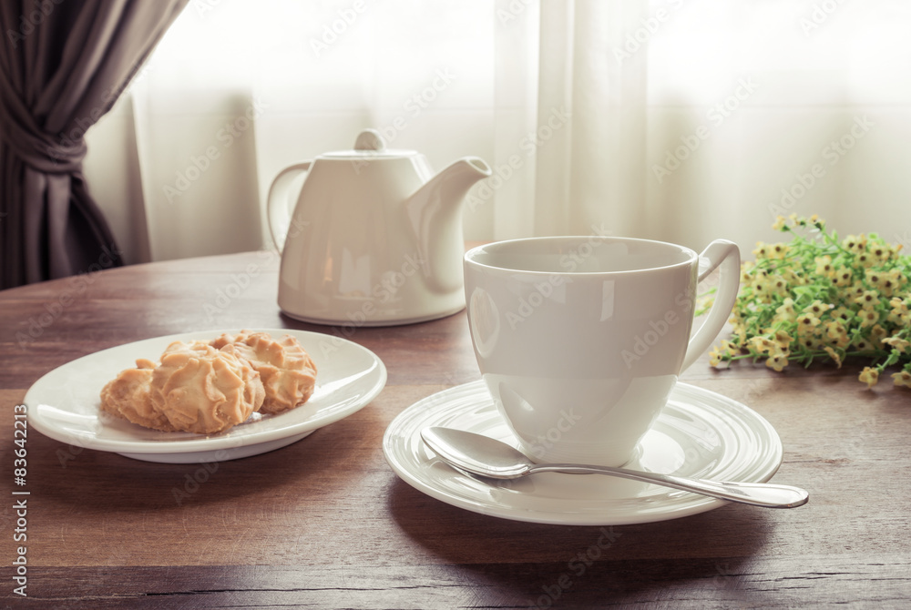 Cup of tea with teapot and cookies on table, vintage style Cup of tea with teapot and cookies on table, vintage style