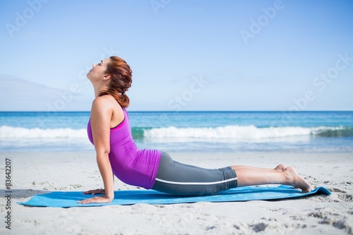 Brunette doing yoga on exercise mat © WavebreakmediaMicro